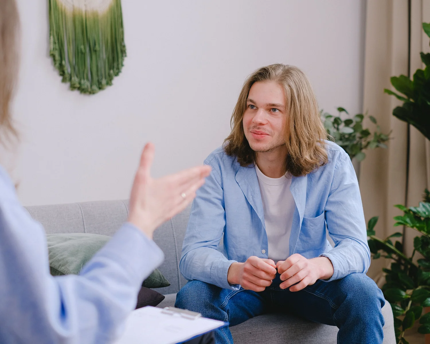 A man talks with a counselor during a seated conversation.
