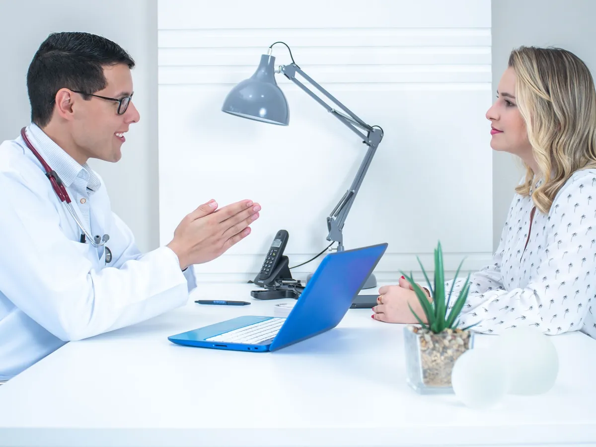 A woman reviews her care options with a clinician.