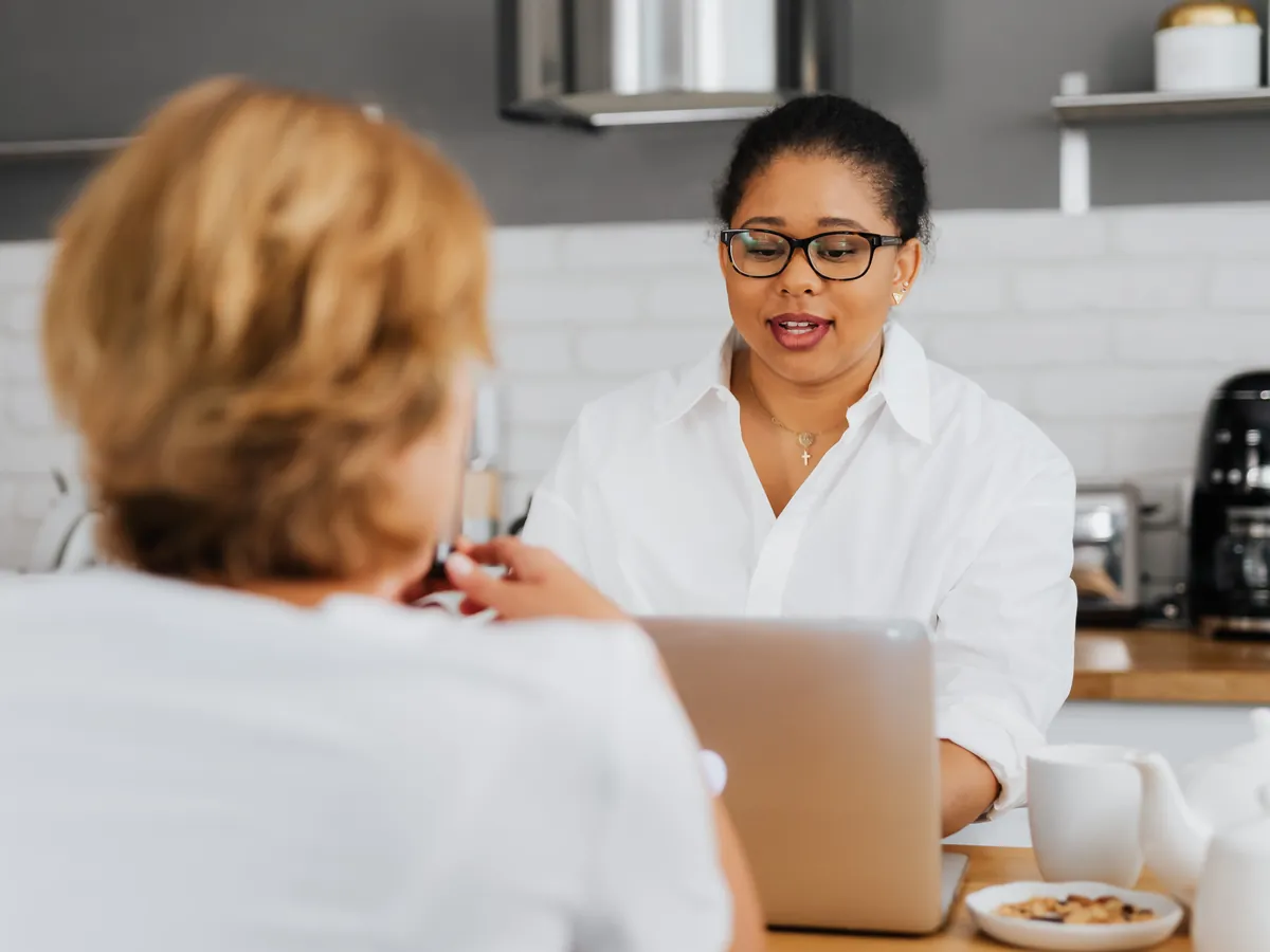 A social worker helps a family caregiver at home.